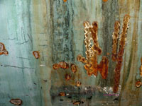 rust from a disk grinder on submarine wall